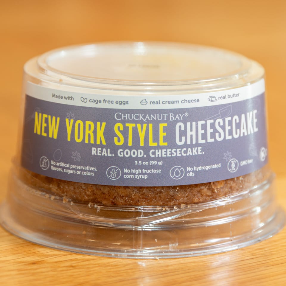 Chuckanut Bay New York Style Cheesecake in a clear plastic container with a purple label.